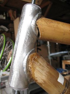 a close up of a metal object on a wooden handlebar in a bike shop