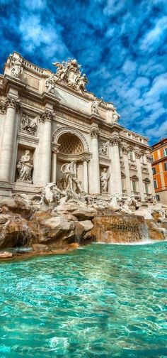 the trezzino fountain in rome, italy with blue sky and clouds above it