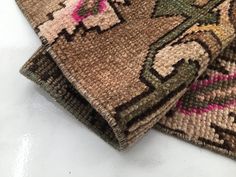 two pieces of woven rugs sitting on top of each other