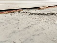 a close up of a window seal on the side of a building with dirt and debris around it