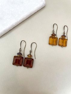 Beautiful fall Czech glass earrings Options: Mustard yellow Brown Length  Approximately 1.75 inches long Nickel-free Amber Czech Glass Earrings, Brown Rectangular Bohemian Earrings, Amber Czech Glass Drop Earrings, Bohemian Brown Rectangular Earrings, Handmade Amber Earrings In Czech Glass, Bohemian Glass Drop Earrings, Granola Earrings, Brown Rectangular Earrings With Ear Wire, Amber Czech Glass Earrings With Ear Wire