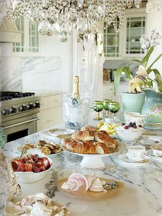 a table topped with plates and bowls filled with food next to a stove top oven