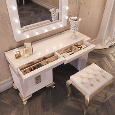 a white vanity with lights on it and a stool