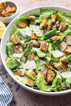 a salad in a white bowl with dressing