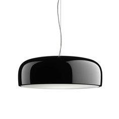 a black and white light hanging from a ceiling