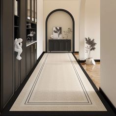 the hallway is clean and ready for guests to use it as an entrance way in this home