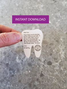 a person holding up a tooth shaped magnet with the words instant download on it