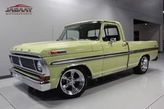 an old pick up truck parked in a garage