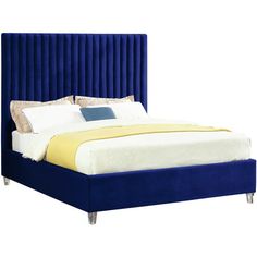 a bed with blue velvet headboard and foot board