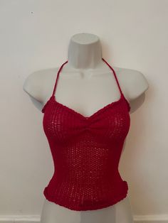 a mannequin wearing a red knitted top