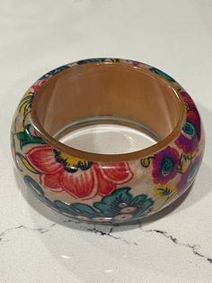 This is a boho chunky lucite bangle 1 1/2" wide 2 1/2" opening Looks like lucite over material Good condition Has lots of color to the bangle, turquoise Orange,yellow, purple and tan background Tan Background, Orange And Turquoise, Yellow Purple, Orange Yellow, Bangle Bracelets, Violet, Jewelry Bracelets