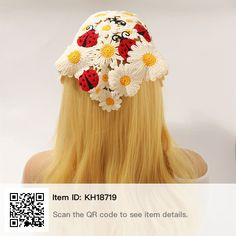 a woman with long blonde hair wearing a ladybug and daisies crochet hat