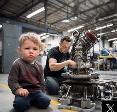 two men working on an engine in a factory with a young boy sitting next to it