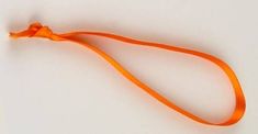 an orange lanyard on a white surface