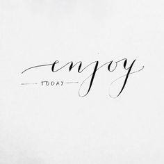 the word enjoy written in cursive writing on a white paper with black ink