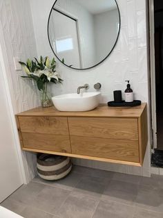 a bathroom with a sink and mirror on the wall