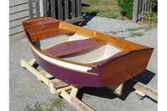 a small wooden boat sitting on top of a pallet