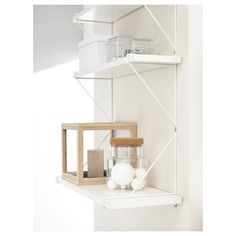 a shelf with some items on top of it and a light fixture in the corner