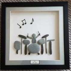 some rocks and musical notes are in a shadow box