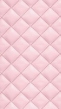 a pink quilted material with white stitching