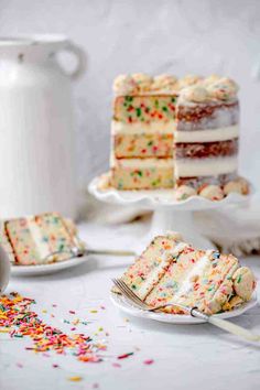 a slice of cake with sprinkles is on a plate next to the rest of the cake