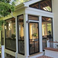 a screened in porch on the side of a house