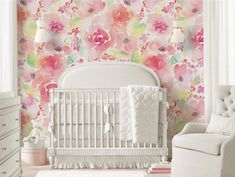 a white crib in front of a floral wallpaper