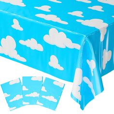 a blue table cloth with white clouds on it