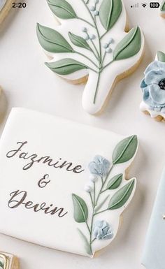 cookies decorated with flowers and leaves are on a table