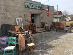 several chairs and tables outside of a building