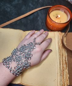 This hand-made hand flower is a great addition to many, many costumes! This small piece of armor is made of aluminum links and is therefore lightweight.   The size should fit most adult hands. the clasp is an easy-to-use loop. With the clasp, the radius of the wrist is about 9.5 inches, the height is about 6 inches from the base to the tip of the finger loop. Joan Of Arc Costume, Hand Flower, Hand Flowers, Chain Maille, Making Jewelry, Jewelry Designs, Chains Jewelry, Metal Working