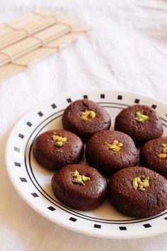 a white plate topped with chocolate cupcakes on top of a table