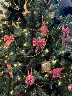 a christmas tree decorated with bows and ornaments