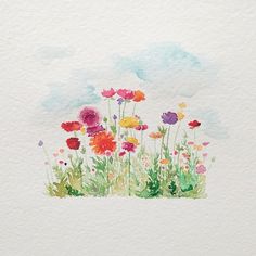 watercolor painting of colorful flowers on white paper with blue sky and clouds in the background