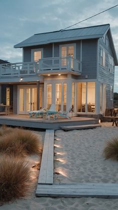 a beach house is lit up at night