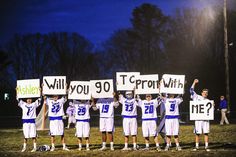 a group of young men holding up signs