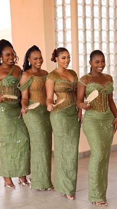 the bridesmaids are dressed in green dresses and gold sequins on them