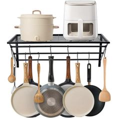 pots and pans are hanging on the rack