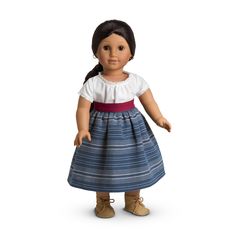 an american girl doll wearing a blue and white dress with red sash, standing on a white background