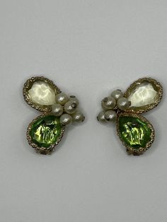 Are they butterfly wings? Flower petals?  Faerie Magic?  What's clear is that they ARE classy, glamorous Kramer earrings, circa 1950s, and ready to accentuate the look you're after.  No cracks or chips, a few light scratches consistent with vintage wear.  Please see pictures and video - reach out with questions. Extra Info: Louis Kramer, with brothers Morris and Henry, began Kramer Jewelry Creations in New York in 1943 and continued production until the late 1970s. The Kramer product and brand h Clip Earrings, Austrian Crystal, Butterfly Wings, Vintage Wear, Jewelry Creation, Flower Petals, Cut Glass, Faux Pearl, Clip On Earrings