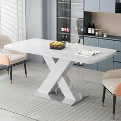 a white dining table with two chairs around it