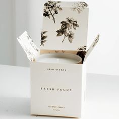 a white box with a black and white flower print on it sitting on a table