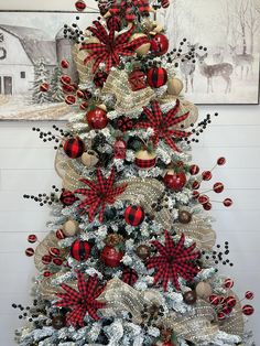 a christmas tree decorated with red, white and black decorations