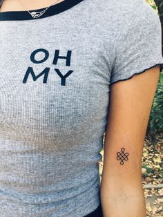 a woman with a tattoo on her arm that says oh my and is holding an umbrella