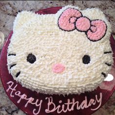 a hello kitty birthday cake on a table