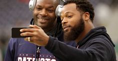 two men with headphones on taking a selfie