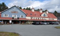 an outside view of a building with cars parked in the parking lot next to it