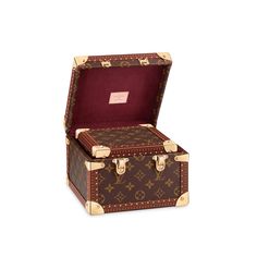 an old suitcase with the lid open on a white background, it is brown and has gold trimmings