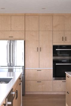 an empty kitchen with wooden cabinets and stainless steel appliance in the center island