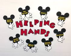 mickey mouse magnets with the words helping hands written in red and white on them